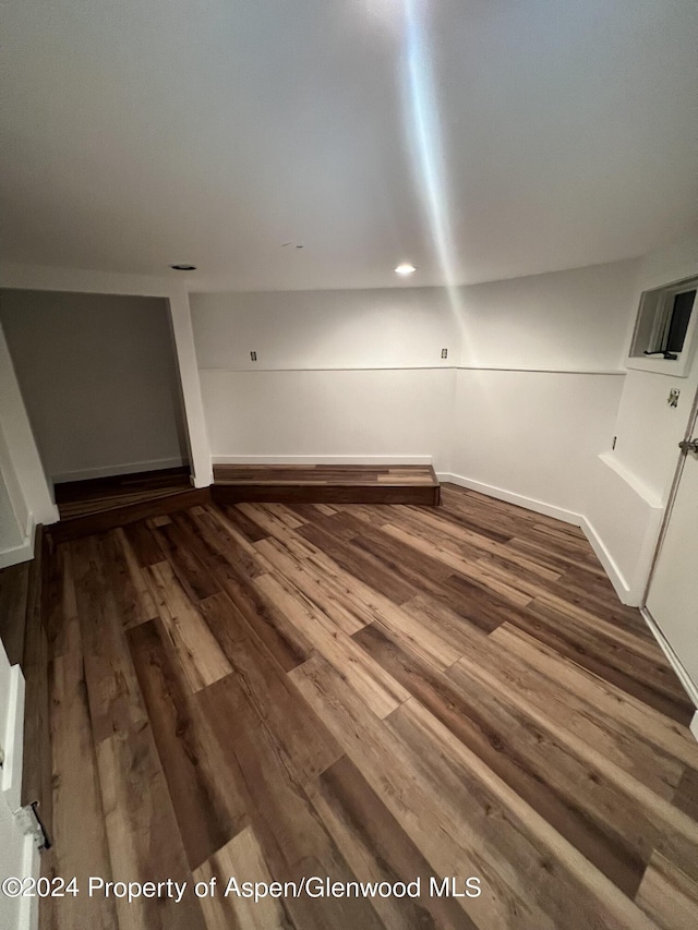 interior space featuring recessed lighting, baseboards, and wood finished floors
