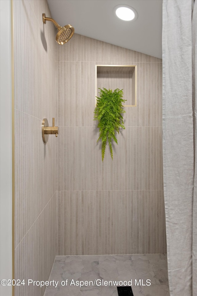 bathroom with tiled shower