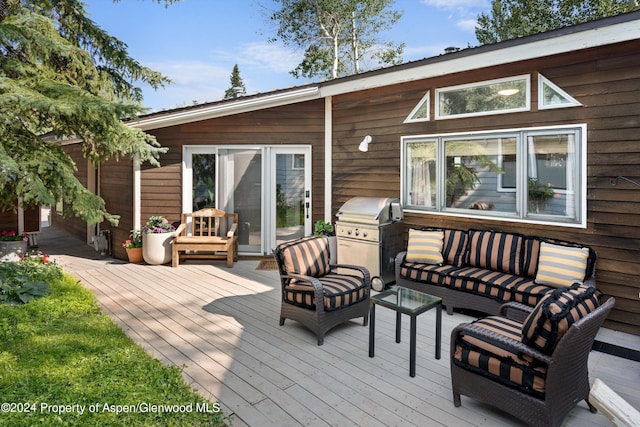 wooden deck featuring an outdoor living space and area for grilling