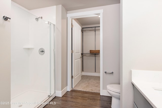 253 Wulfsohn Rd Unit 312, Glenwood Springs, CO 81601 - full bathroom featuring a stall shower, vanity, wood finished floors, toilet, and baseboards