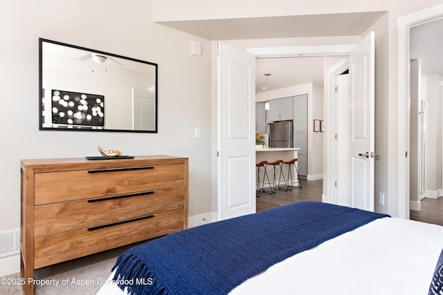 253 Wulfsohn Rd Unit 312, Glenwood Springs, CO 81601 - bedroom featuring freestanding refrigerator, baseboards, and wood finished floors