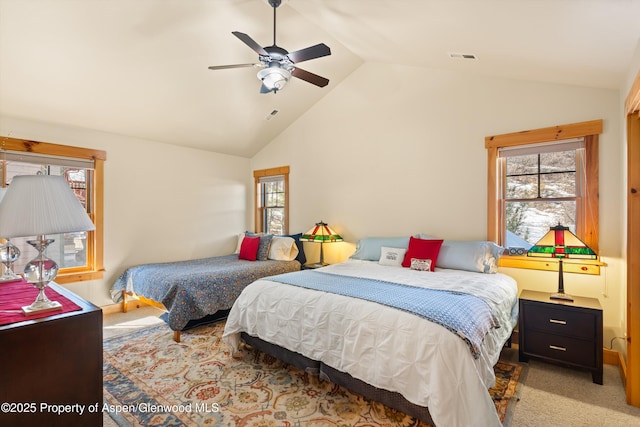 carpeted bedroom featuring lofted ceiling, ceiling fan, and visible vents