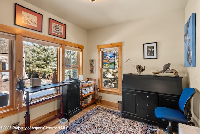 office area featuring light wood-style flooring and baseboards