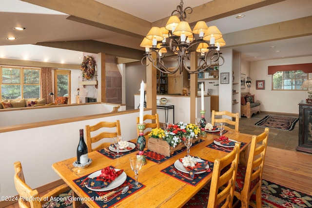 dining area with beam ceiling and a chandelier