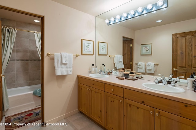 bathroom with tile patterned flooring, vanity, and shower / bathtub combination with curtain