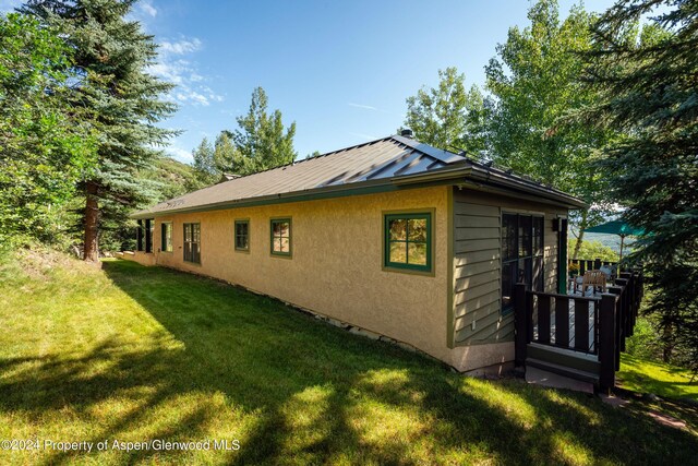 view of home's exterior featuring a yard