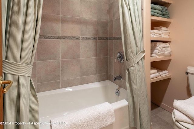 bathroom with tile patterned floors, shower / bath combination with curtain, and toilet