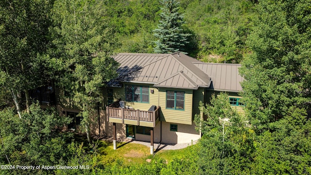 rear view of property with a patio and a wooden deck