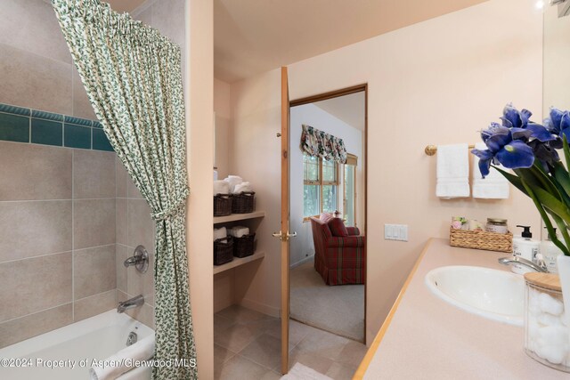 bathroom featuring tile patterned floors, vanity, and shower / tub combo