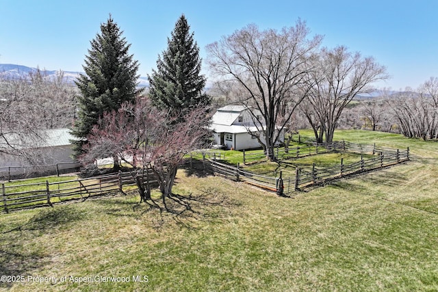 view of yard with a rural view and fence