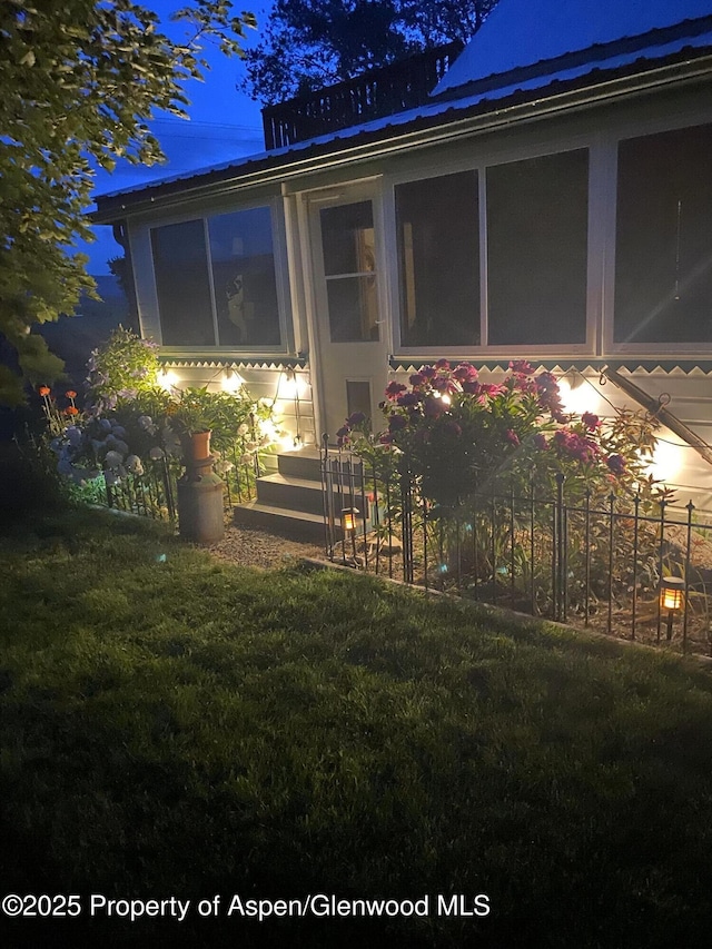 58590 Pe 3/10 Rd, Collbran, CO 81624 - back of house at twilight featuring a lawn