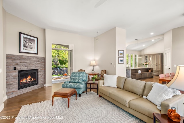 587 Hillcrest Dr, Basalt, CO 81621 - living room with wood finished floors, a stone fireplace, vaulted ceiling, and recessed lighting