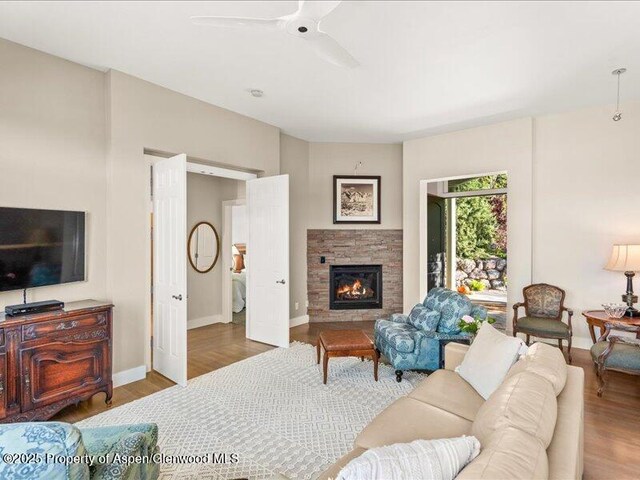 587 Hillcrest Dr, Basalt, CO 81621 - living area with a fireplace, wood finished floors, baseboards, and a ceiling fan
