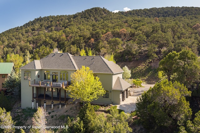 587 Hillcrest Dr, Basalt, CO 81621 - view of subject property featuring a forest and a mountainous background