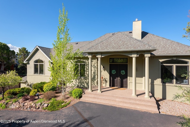 587 Hillcrest Dr, Basalt, CO 81621 - view of front of house featuring stucco siding, a chimney, and a shingled roof