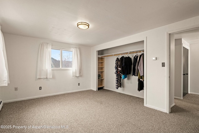 unfurnished bedroom featuring a closet, baseboards, and carpet floors