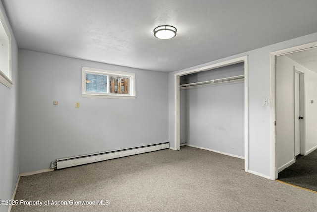 unfurnished bedroom featuring carpet flooring, baseboards, a closet, and a baseboard radiator