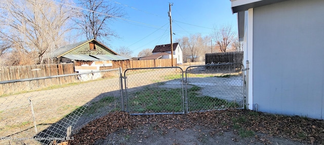 view of yard featuring fence and a gate