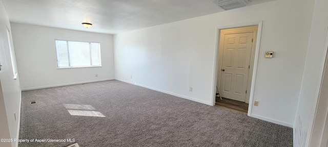 carpeted spare room with visible vents and baseboards