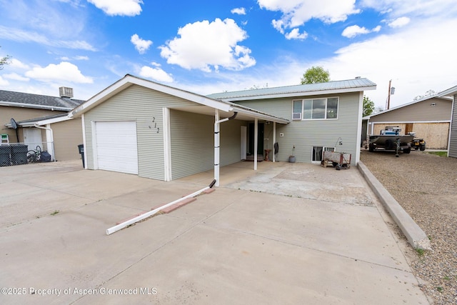 212 River Rd, Rangely, CO 81648 - tri-level home featuring driveway and an attached garage
