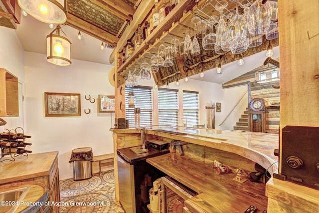 dining room featuring log walls and vaulted ceiling