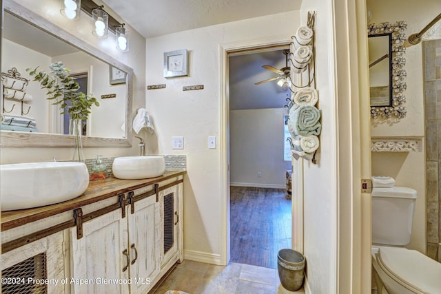 bathroom with a textured ceiling, vanity, toilet, and wood-type flooring