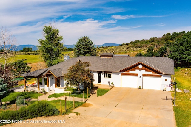 1459 County Road 102, Carbondale, CO 81623 - ranch-style house with a garage, a mountain view, and a front lawn