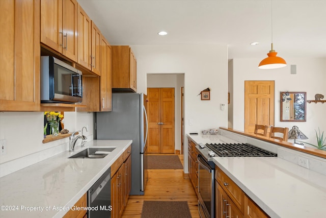 1459 County Road 102, Carbondale, CO 81623 - kitchen with sink, light stone counters, decorative light fixtures, light hardwood / wood-style flooring, and stainless steel appliances