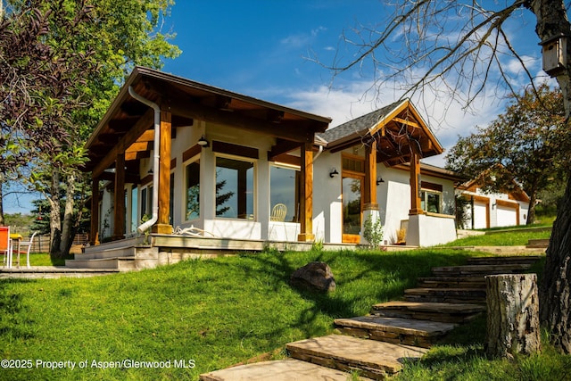 1459 County Road 102, Carbondale, CO 81623 - view of front of property featuring a garage, a front yard, and covered porch
