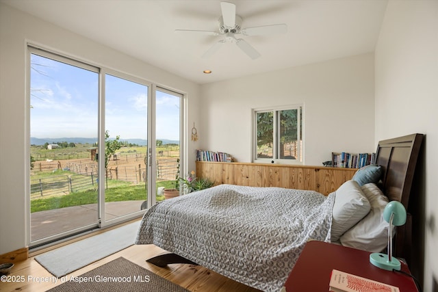 1459 County Road 102, Carbondale, CO 81623 - bedroom featuring ceiling fan, wood-type flooring, a rural view, and access to outside