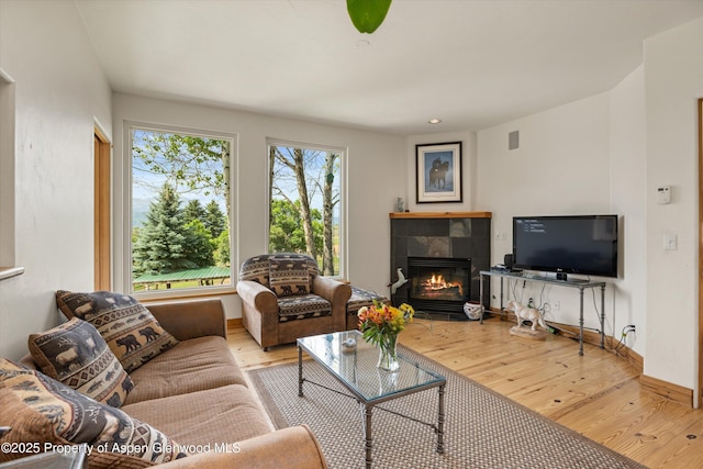 1459 County Road 102, Carbondale, CO 81623 - living room with a tile fireplace and light hardwood / wood-style flooring