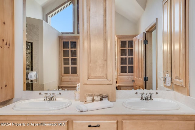 bathroom with vanity and vaulted ceiling