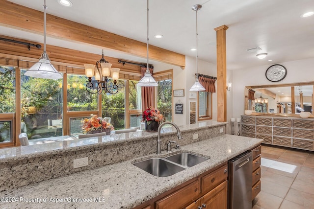 kitchen featuring beamed ceiling, light stone counters, sink, and hanging light fixtures