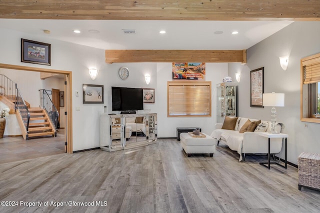 living room with light hardwood / wood-style flooring and beamed ceiling