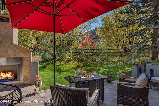 view of patio featuring an outdoor stone fireplace