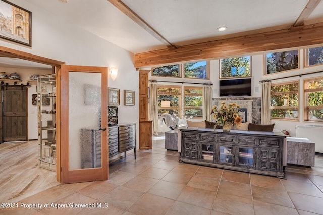 bar featuring beam ceiling, a fireplace, high vaulted ceiling, and light tile patterned floors