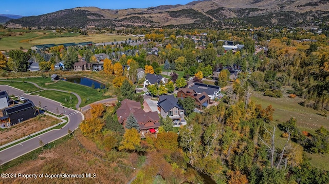 aerial view featuring a water and mountain view