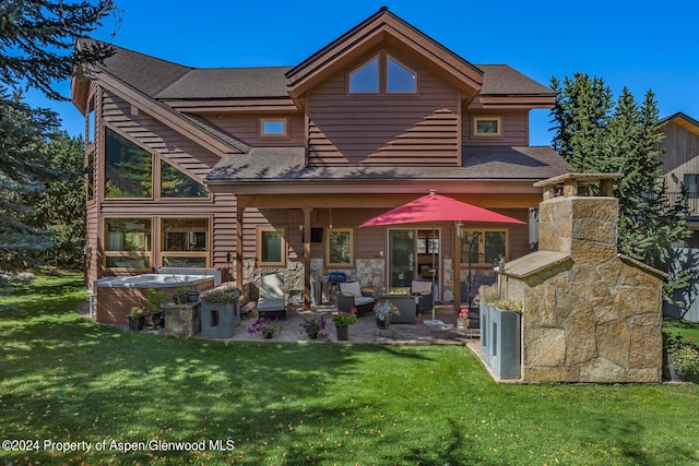 rear view of house featuring a lawn, a patio area, and outdoor lounge area