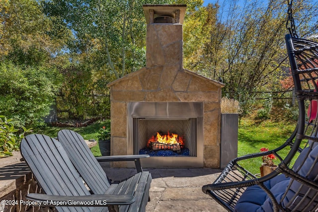 view of patio with an outdoor stone fireplace