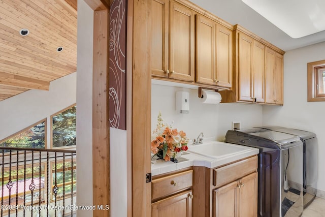 washroom with washer and dryer, cabinets, wooden ceiling, and sink