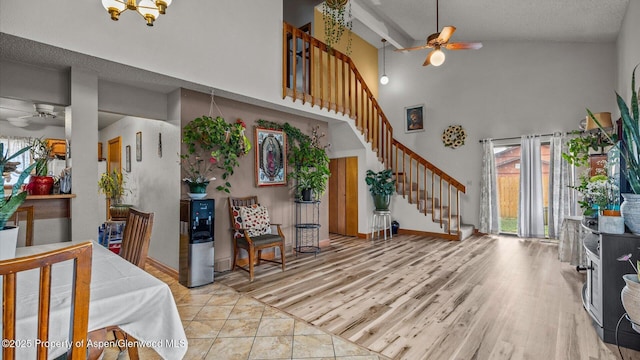 500 Fairway Ave, Rifle, CO 81650 - entryway featuring ceiling fan, high vaulted ceiling, stairs, light wood-style floors, and baseboards