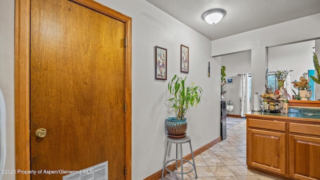 500 Fairway Ave, Rifle, CO 81650 - hall with light tile patterned floors and a textured ceiling