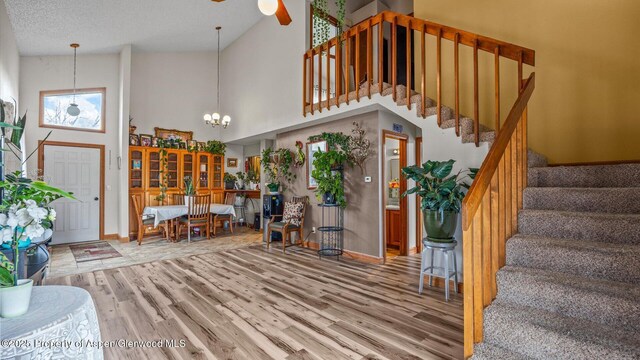 500 Fairway Ave, Rifle, CO 81650 - entryway with high vaulted ceiling, wood finished floors, stairs, ceiling fan, and baseboards
