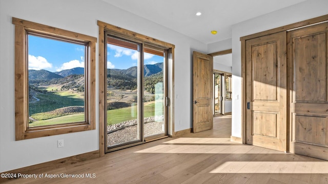 doorway to outside with a mountain view and light hardwood / wood-style floors