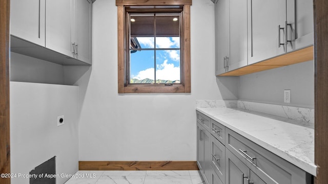 laundry room with cabinets and hookup for an electric dryer