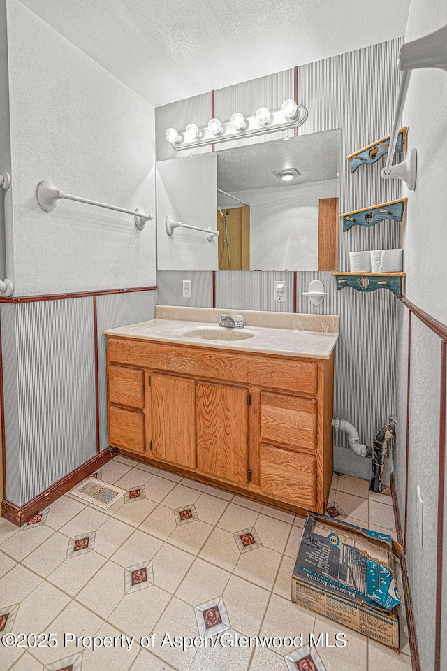 5990 County Road 7, Craig, CO 81625 - full bathroom featuring vanity, tile patterned floors, and wainscoting