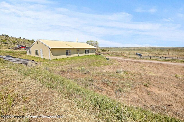 5990 County Road 7, Craig, CO 81625 - rear view of house featuring an outbuilding and a view of rural / pastoral area