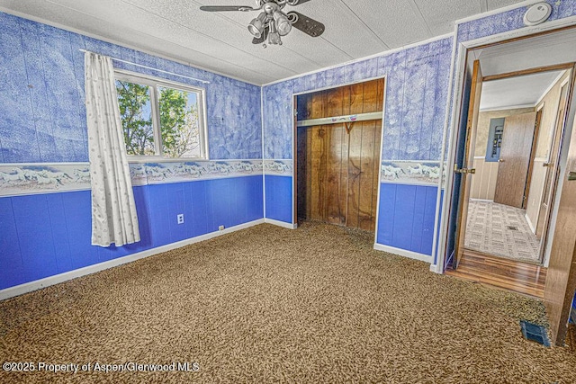 5990 County Road 7, Craig, CO 81625 - unfurnished bedroom featuring wallpapered walls, a wainscoted wall, carpet floors, a closet, and ornamental molding