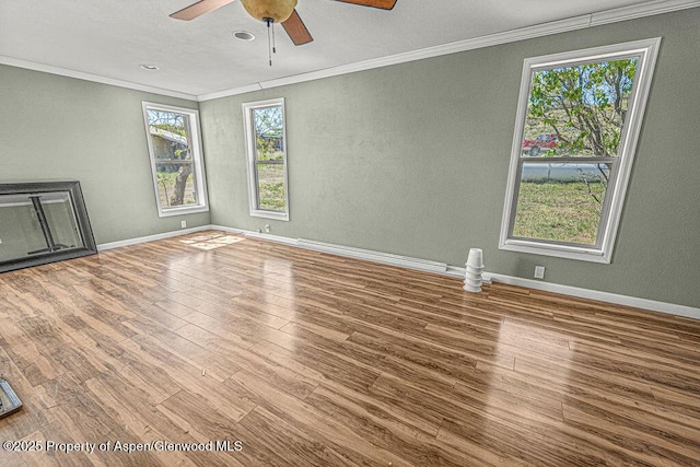 5990 County Road 7, Craig, CO 81625 - unfurnished living room with crown molding, wood finished floors, ceiling fan, a textured wall, and baseboards