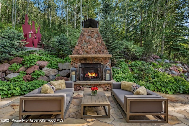 view of patio with an outdoor living space with a fireplace